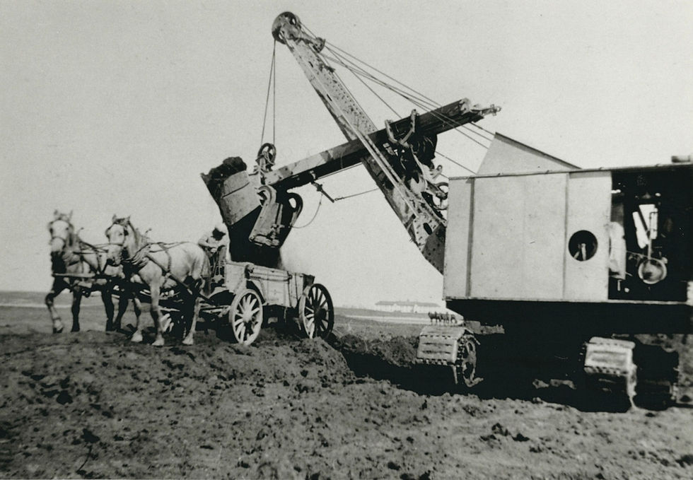 Horses pulling machinery, man operating heavy equipment, earth moving, vintage image.